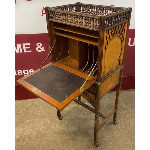 99 - A Victorian Moorish style carved walnut, double sided writing cabinet