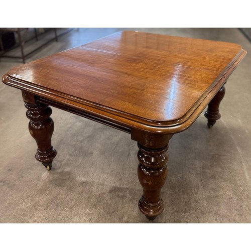 132 - A Victorian walnut extending dining table