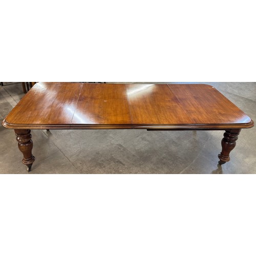 132 - A Victorian walnut extending dining table