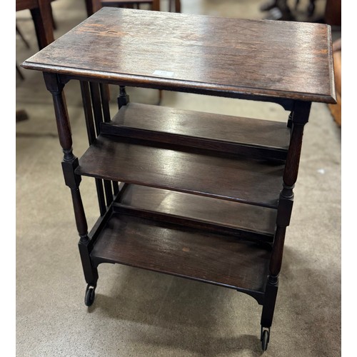 136 - An Arts and Crafts oak three tier bookstand/table