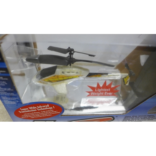 5073 - An X-Rotor Series PIC00-Z remote control helicopter, boxed with remote, a Syma remote control helico... 