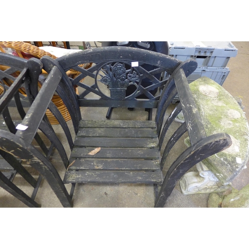 5180 - A pair of cast iron and wood garden armchairs and one other garden chair