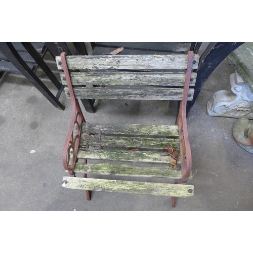 5180 - A pair of cast iron and wood garden armchairs and one other garden chair