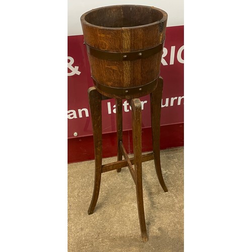 130 - An early 20th Century Listers oak jardiniere on stand