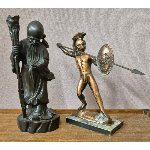 273 - A Chinese carved wood figure of a sage and a copper effect figure of a Spartan