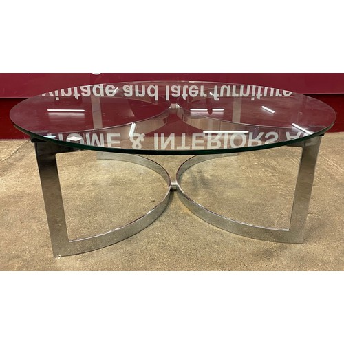 23A - A Merrow Associates chrome and glass topped circular coffee table, designed by Richard Young