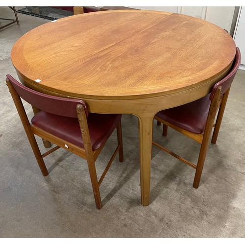 32 - A Nathan teak circular extending dining table and four chairs