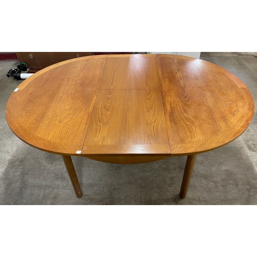 32 - A Nathan teak circular extending dining table and four chairs