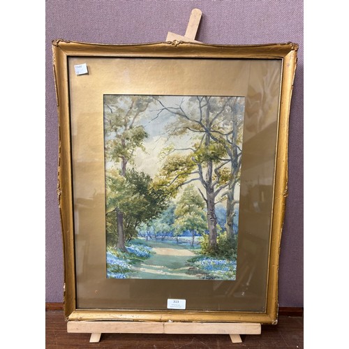 313 - A woodland landscape, framed on a beech artists easel