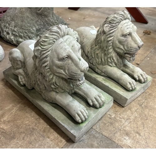 236 - A pair of concrete garden figures of recumbent lions