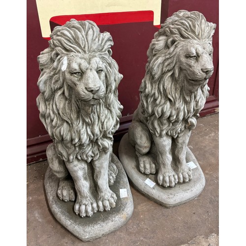 238 - A pair of concrete garden figures of seated lions