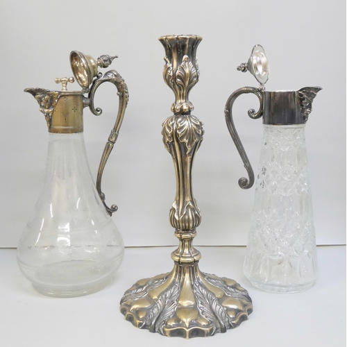 2006 - Two claret jugs, one with etched glass and inner stopper, and a candlestick with leaf detail, candle... 