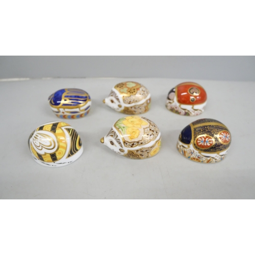 2046 - A collection of six Royal Crown Derby hedgehog paperweights with gold stoppers