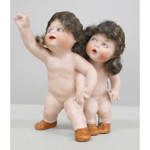 2049 - A German bisque figure group of two children, 11.5cm