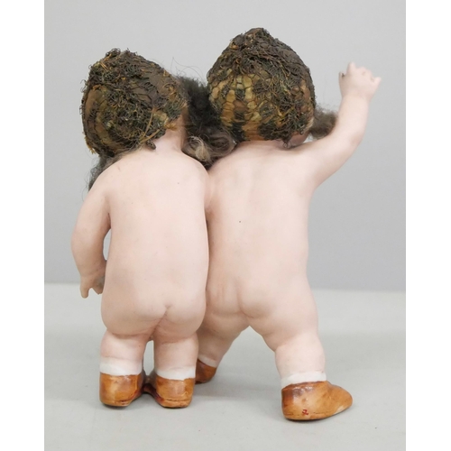 2049 - A German bisque figure group of two children, 11.5cm