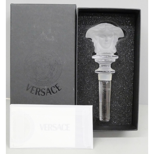 2055 - A Versace clear glass bottle stopper, boxed