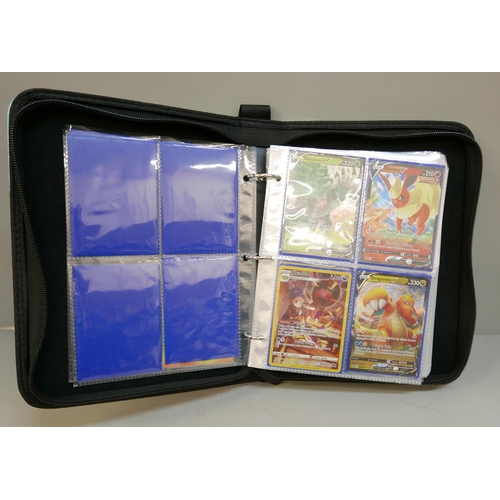 2095 - A folder of Pokémon holographic cards, including first print blue logo Charizard Tops