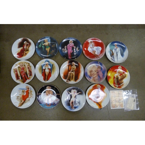 2308 - A collection of Marilyn Monroe items including a set of 14 collectors plates, a sheet of stamps, two... 