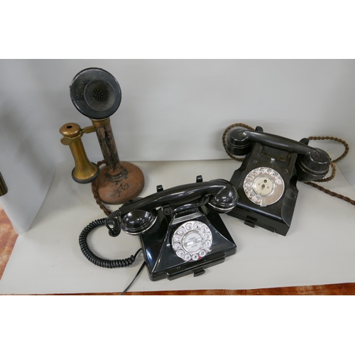 2314 - Three telephones comprising an early 20th Century candlestick phone, a 1940s Bakelite phone and a mo... 