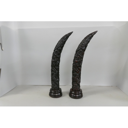 2318 - Three resin models of tusks and a wooden centrepiece