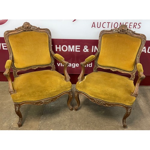 119B - A pair of French Louis XV style carved beech and fabric upholstered fauteuil chairs