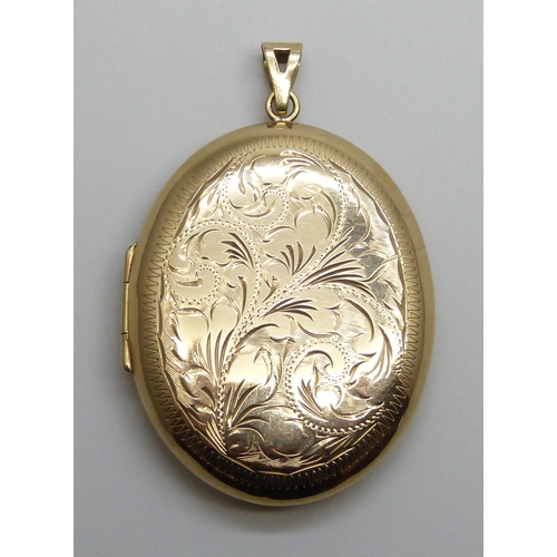 7002 - A large 9ct gold floral engraved locket, 16.1g, 37mm wide