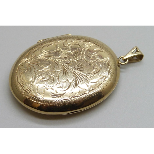 7002 - A large 9ct gold floral engraved locket, 16.1g, 37mm wide