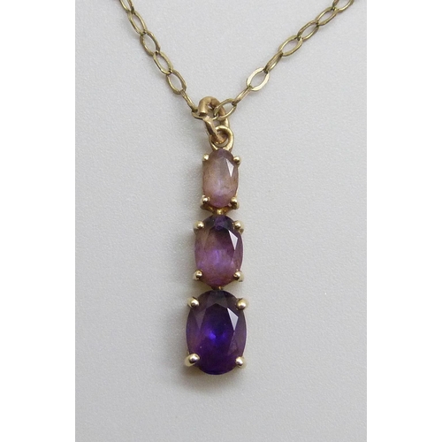 7010 - A 9ct and amethyst pendant on a 9ct gold chain, 1.7g