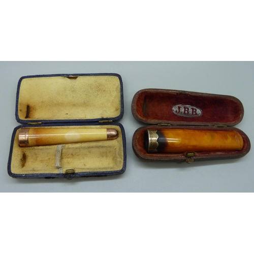 7053 - A 9ct gold mounted cigarette holder, London 1901 and a similar butterscotch amber example with silve... 