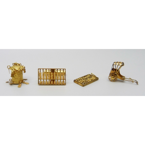 7063 - Three 14ct gold charms and a single cufflink, 6.8g