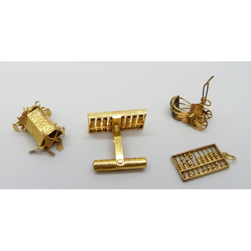 7063 - Three 14ct gold charms and a single cufflink, 6.8g