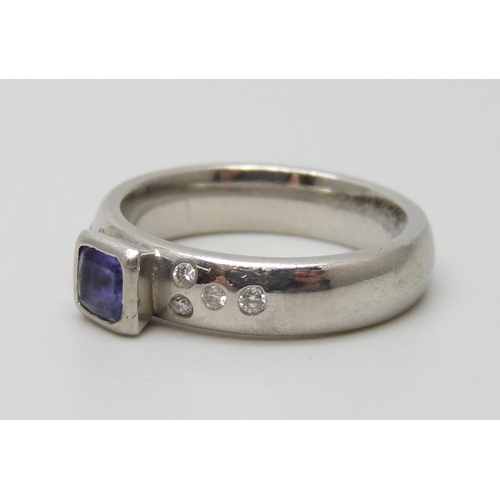 7074 - A handmade platinum ring set with a square tanzanite and diamond shoulders, 8.9g, K