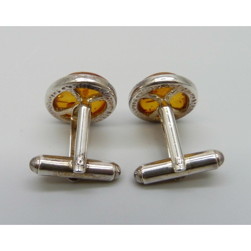 7113 - A pair of silver and oval amber cufflinks, 8.2g