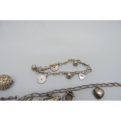 7128 - Three silver charm bracelets, together with loose charms A/F, 66.5g