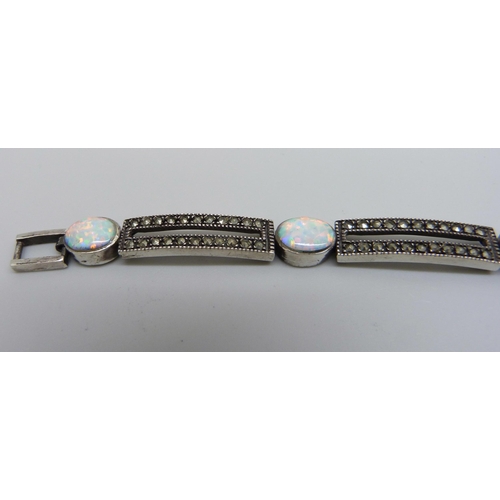 7129 - A silver, marcasite and synthetic opal bracelet, 23.1g