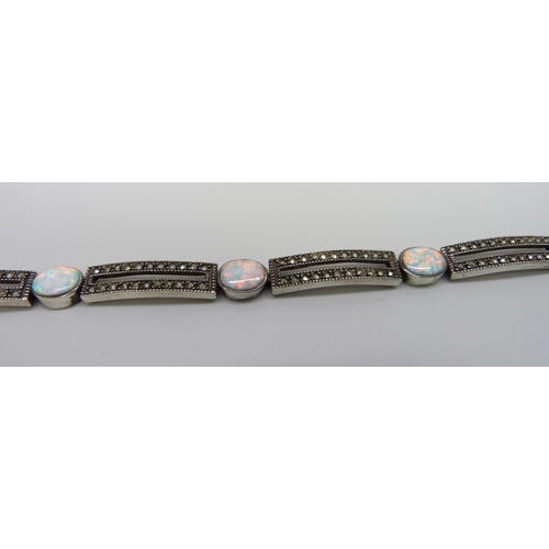 7129 - A silver, marcasite and synthetic opal bracelet, 23.1g