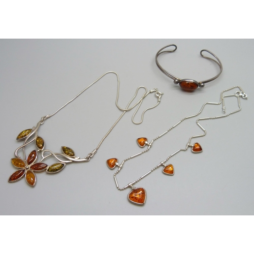 7133 - Two silver and amber necklets and a silver and amber bangle