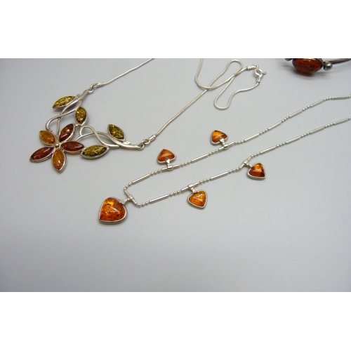 7133 - Two silver and amber necklets and a silver and amber bangle