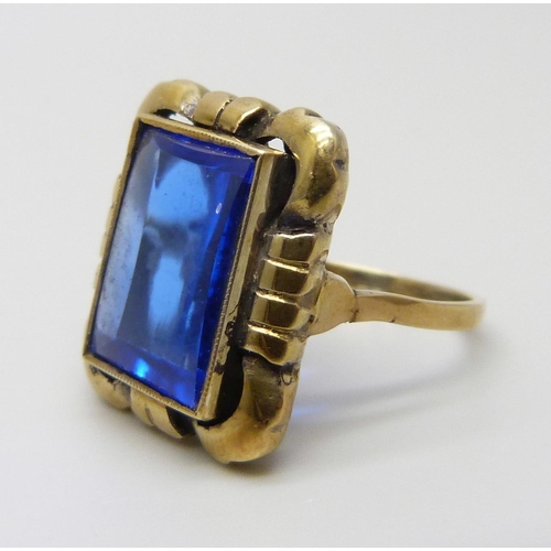 7138 - A silver gilt cushion shape blue stone ring, O, marked 830