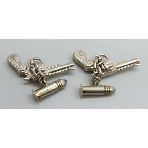 7147 - A pair of novelty silver cufflinks, revolver and bullet, boxed