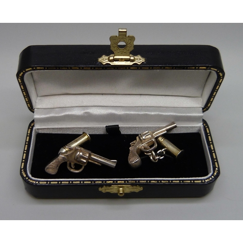 7147 - A pair of novelty silver cufflinks, revolver and bullet, boxed