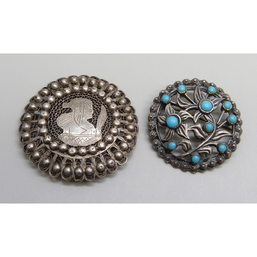 7148 - Two brooches, Egyptian white metal with pharaoh and a turquoise stone set example