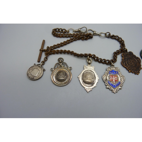 7151 - Five silver fob medals including one football, one tug-of-war and one enamelled, two other medallion... 