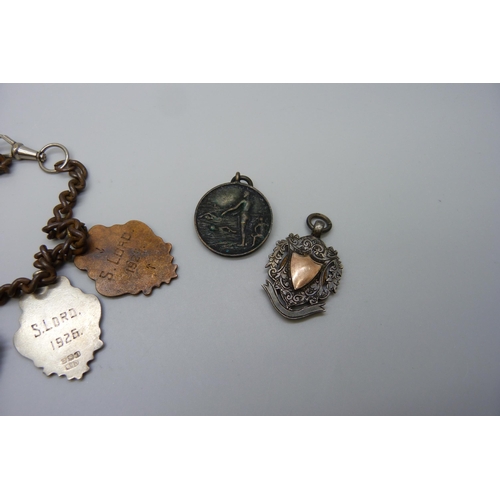 7151 - Five silver fob medals including one football, one tug-of-war and one enamelled, two other medallion... 