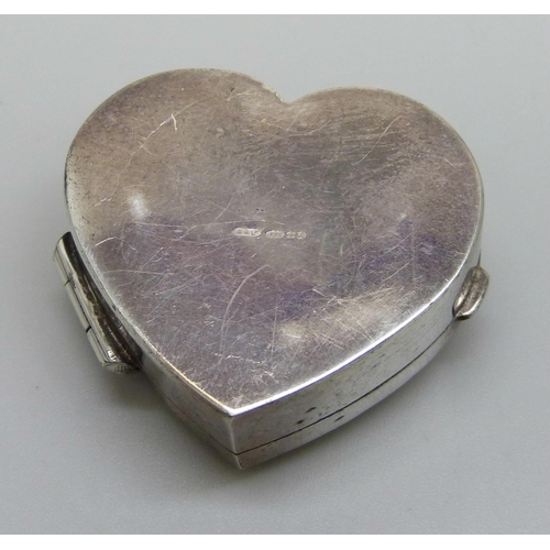 7152 - A heart shaped silver pill box with engraved decoration