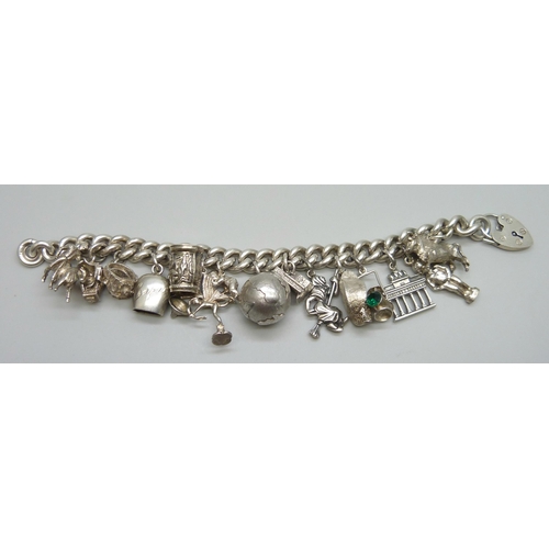 7157 - A heavy silver charm bracelet, 114g