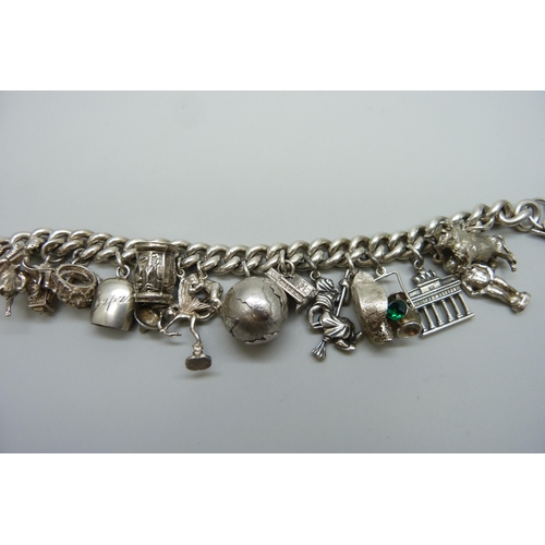 7157 - A heavy silver charm bracelet, 114g