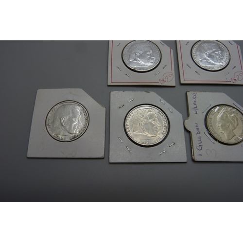 7167 - A group of six silver coins, 1929, one Gulden, 1945 ½ dollar, 1937, 1938 and two 1939 five Reichs Ma... 