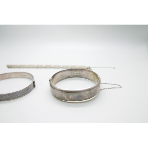 7238 - Two silver bangles and a bracelet