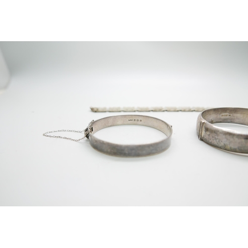 7238 - Two silver bangles and a bracelet